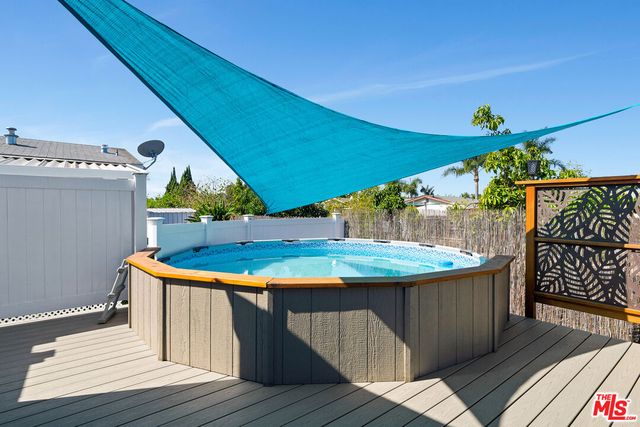 a view of a wooden roof deck with furniture