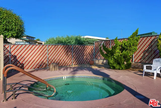 a view of a backyard with plants and outdoor seating