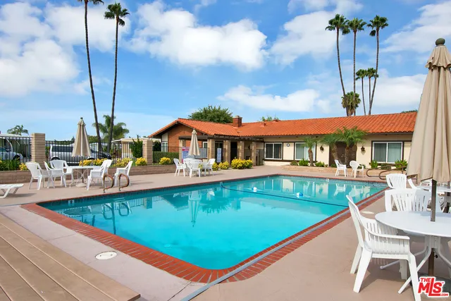 an outdoor view of swimming pool with outdoor seating