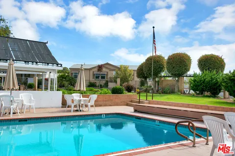 a front view of house with yard and outdoor seating