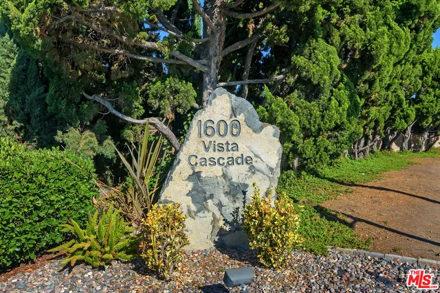 a sign that is sitting in front of flowers