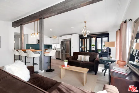 a living room with lots of furniture and a large window