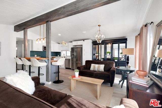 a living room with lots of furniture and a large window