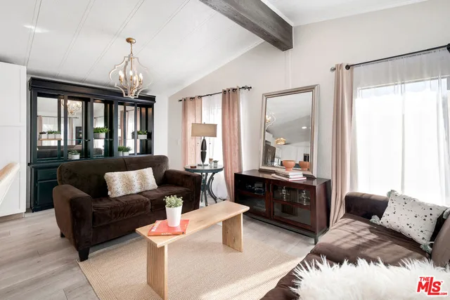 a living room with furniture fireplace and a large window