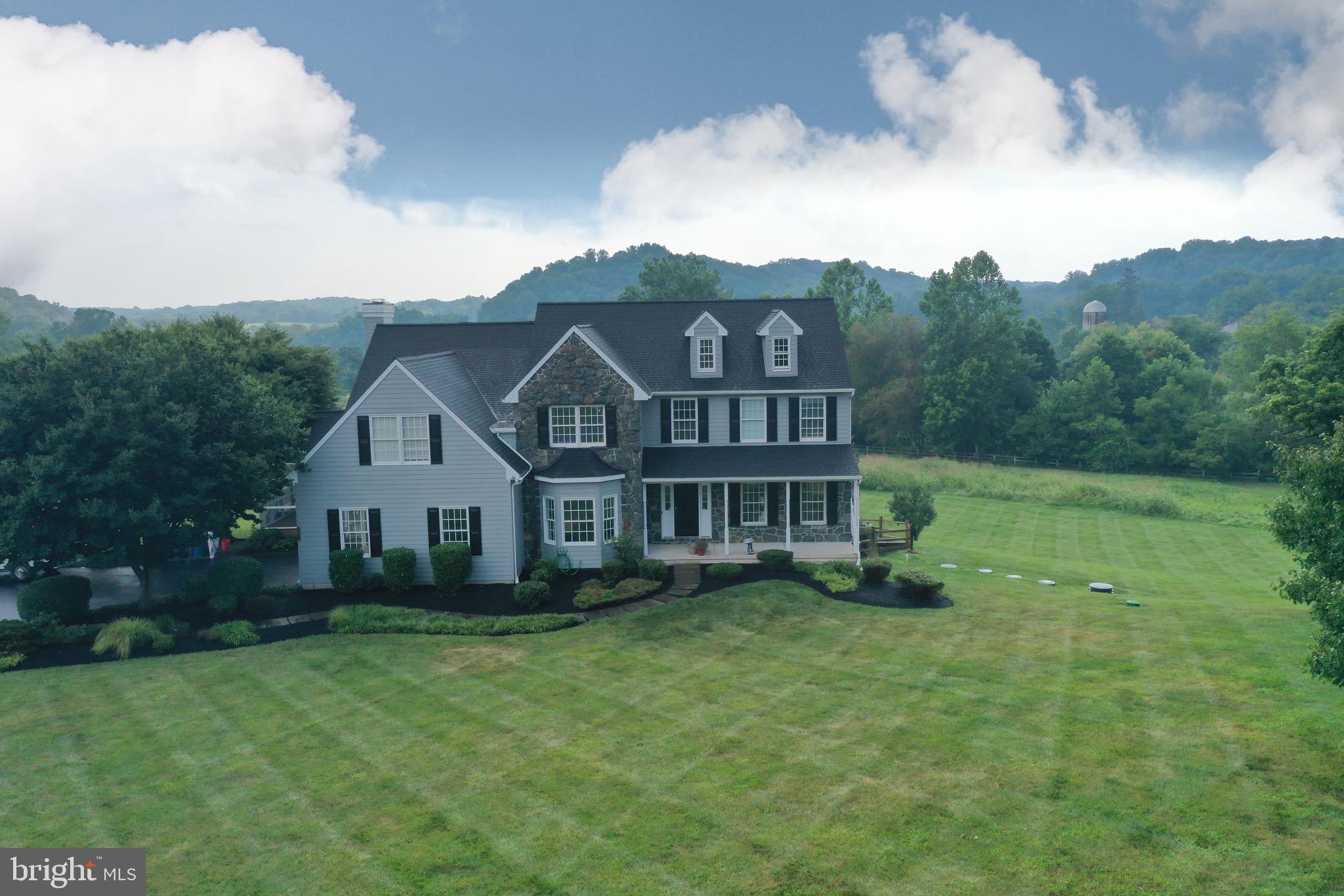 106 Sawmill Road Landenberg, PA 19350 - Photo 2 of 4 a view of a house with a big yard and large trees