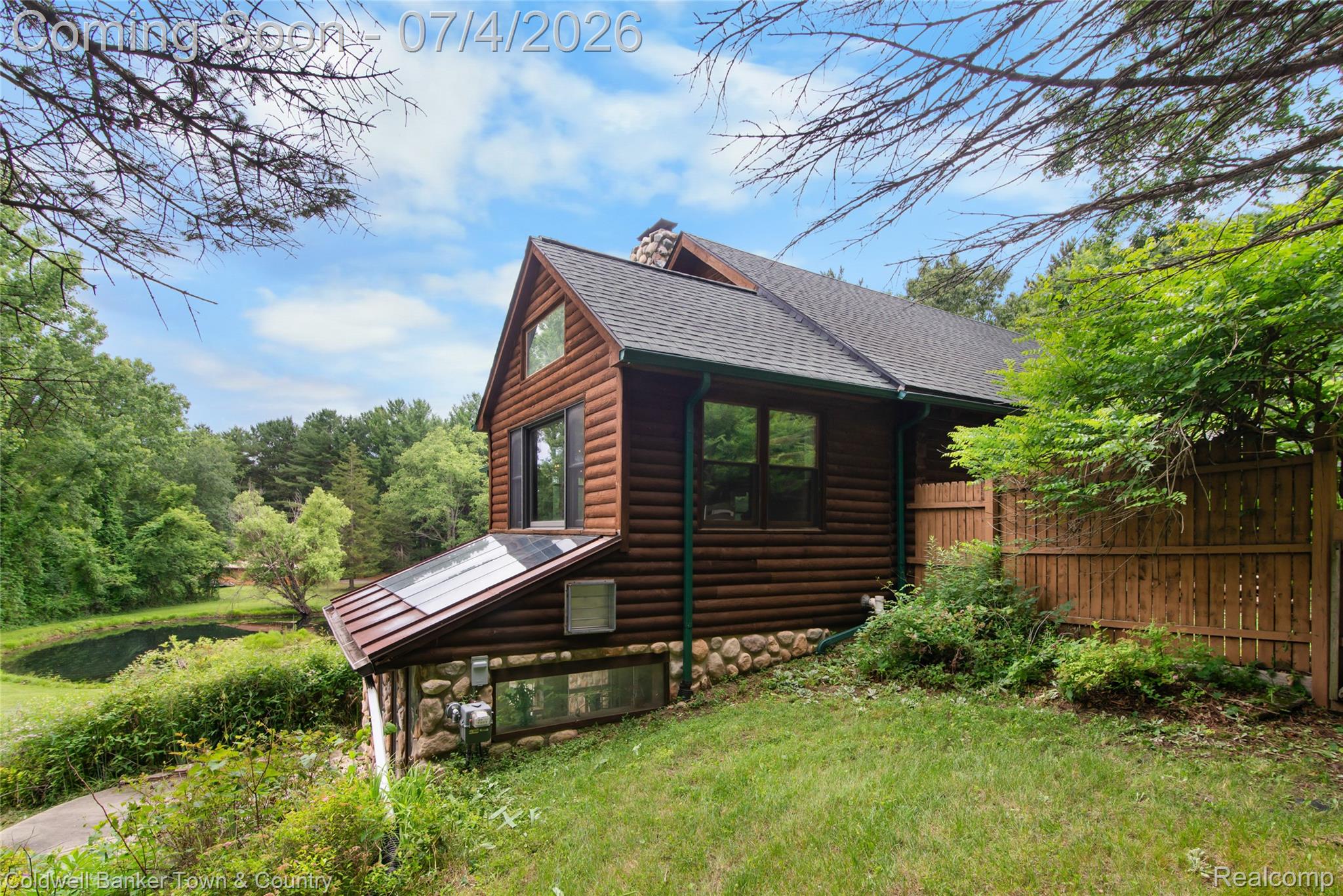 7335 Richardson Road Howell, MI 48843 - Photo 11 of 54 Log cabin exterior featuring a stone foundation and a dark shingle roof