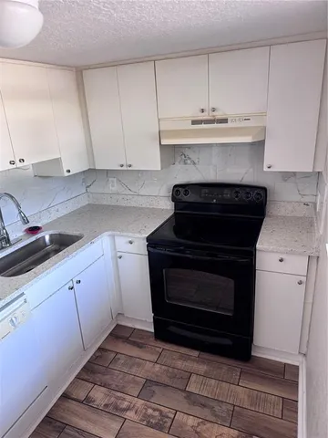 a kitchen with a stove and a sink