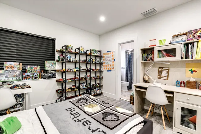a work room with furniture a rug and a window