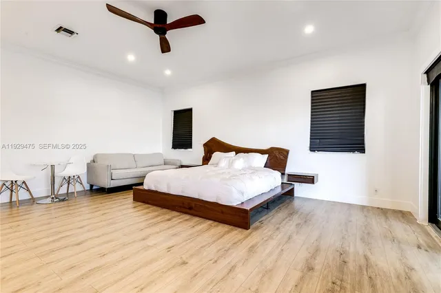 a bedroom with two beds and a wooden floor