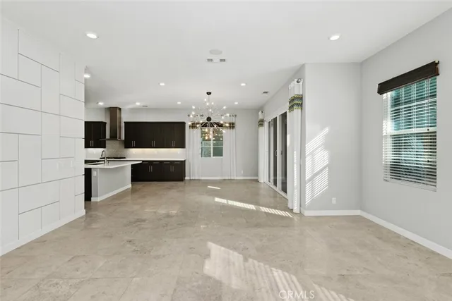 a large kitchen with stainless steel appliances a large counter top