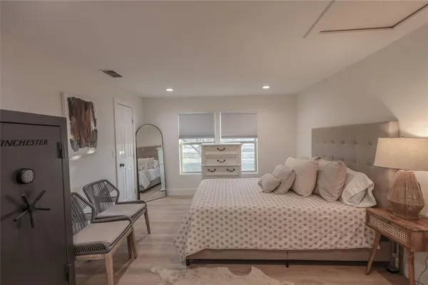 a bedroom with a bed and chair
