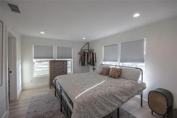 a bedroom with a large bed and a dresser