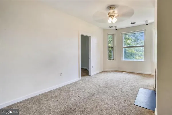 an empty room with windows and closet