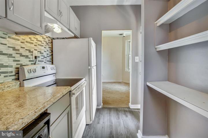 1900 3rd Street Northwest, Unit 2 Washington, DC 20001 - Photo 10 of 14 a kitchen with stainless steel appliances granite countertop a refrigerator and a stove