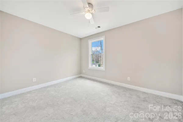 a spacious bathroom with a double vanity sink toilet mirror and double
