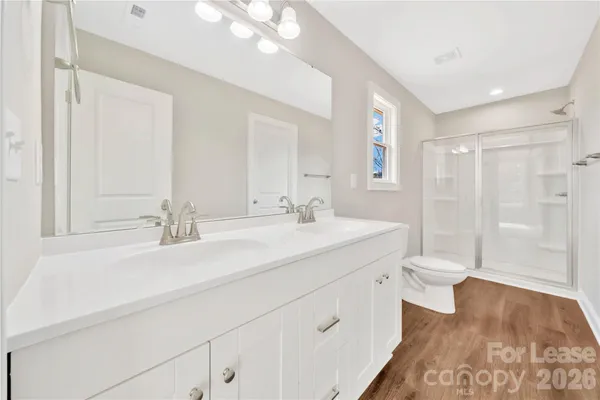 a bathroom with a sink double vanity and a mirror