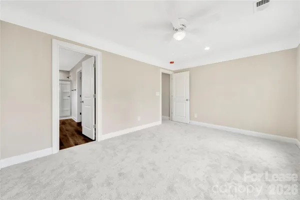 an empty room with windows and closet