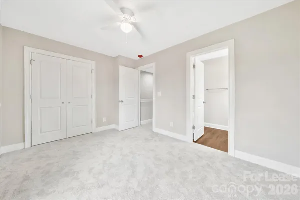 a kitchen with granite countertop a sink and white cabinets