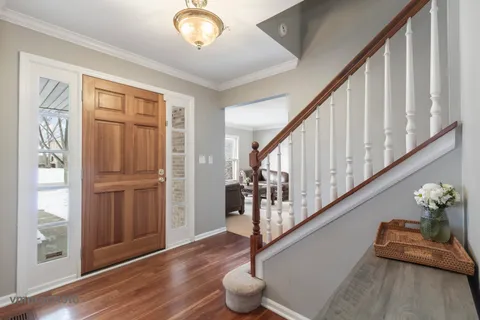 a view of entryway with wooden floor and stairs
