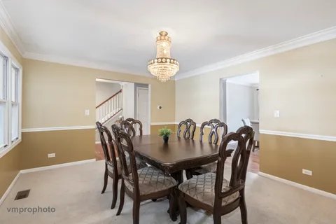 a view of a dining room with furniture and window