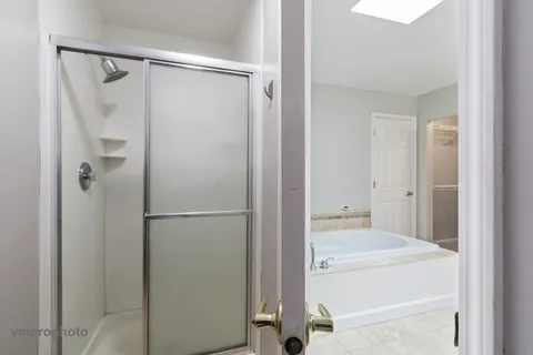 a bathroom with a tub and a shower