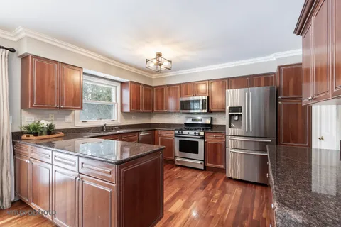 a kitchen with a refrigerator stove and sink