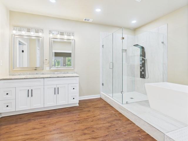 910 Cream Level Road Athens, TX 75751 - Photo 15 of 40 a spacious bathroom with a double vanity sink a mirror and a bathtub