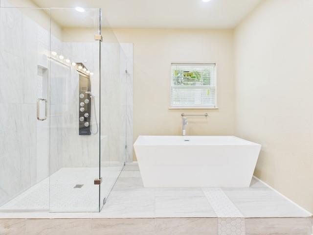 910 Cream Level Road Athens, TX 75751 - Photo 16 of 40 a white bath tub sitting next to a white sink