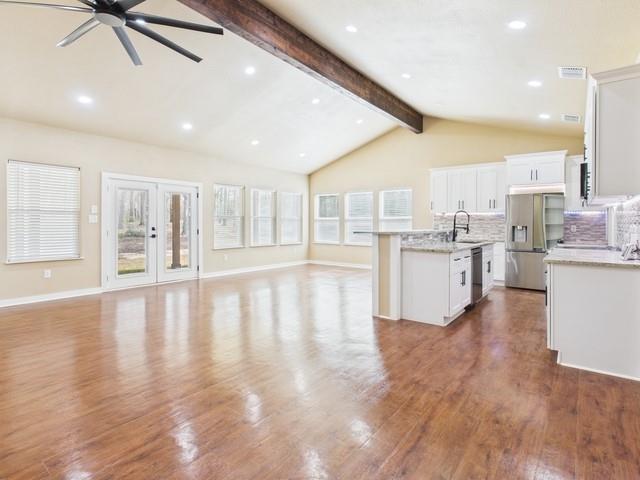 910 Cream Level Road Athens, TX 75751 - Photo 6 of 40 a large white kitchen with lots of counter space wooden floor and appliances