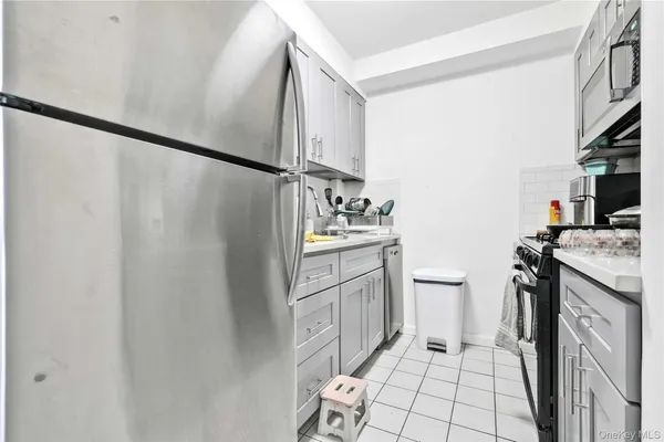 a kitchen with white cabinets and white appliances