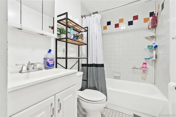 a bathroom with a sink toilet vanity and bathtub