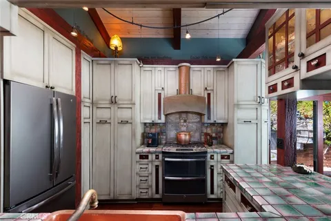 a kitchen with stainless steel appliances granite countertop a refrigerator and a stove