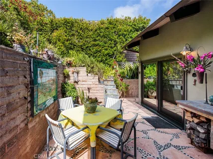 a view of a patio with a table chairs and a potted plant