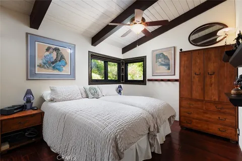 a bedroom with a bed and a painting on the wall