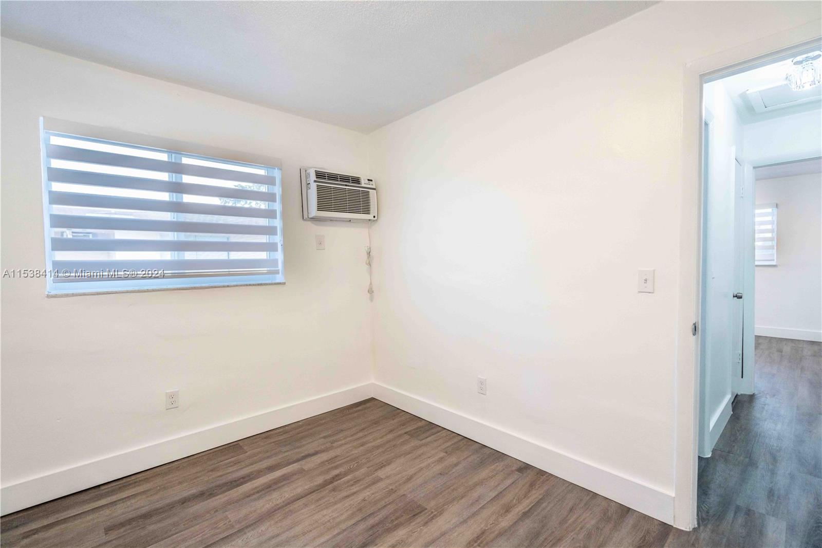 1945 Northwest 29th Street, Unit 8 Miami, FL 33142 - Photo 16 of 31 a view of a small space with wooden floor and a window