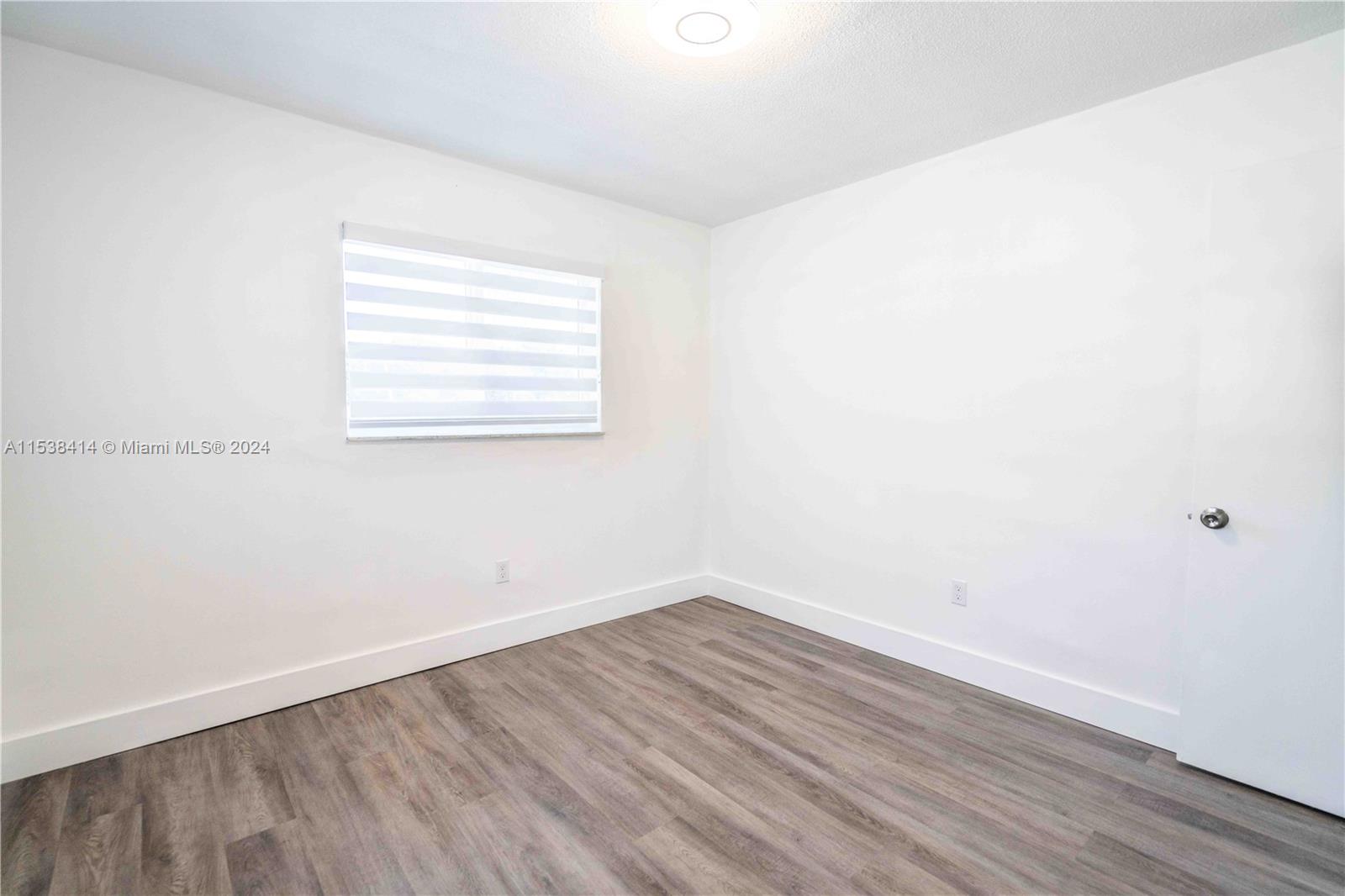 1945 Northwest 29th Street, Unit 8 Miami, FL 33142 - Photo 26 of 31 wooden floor in an empty room