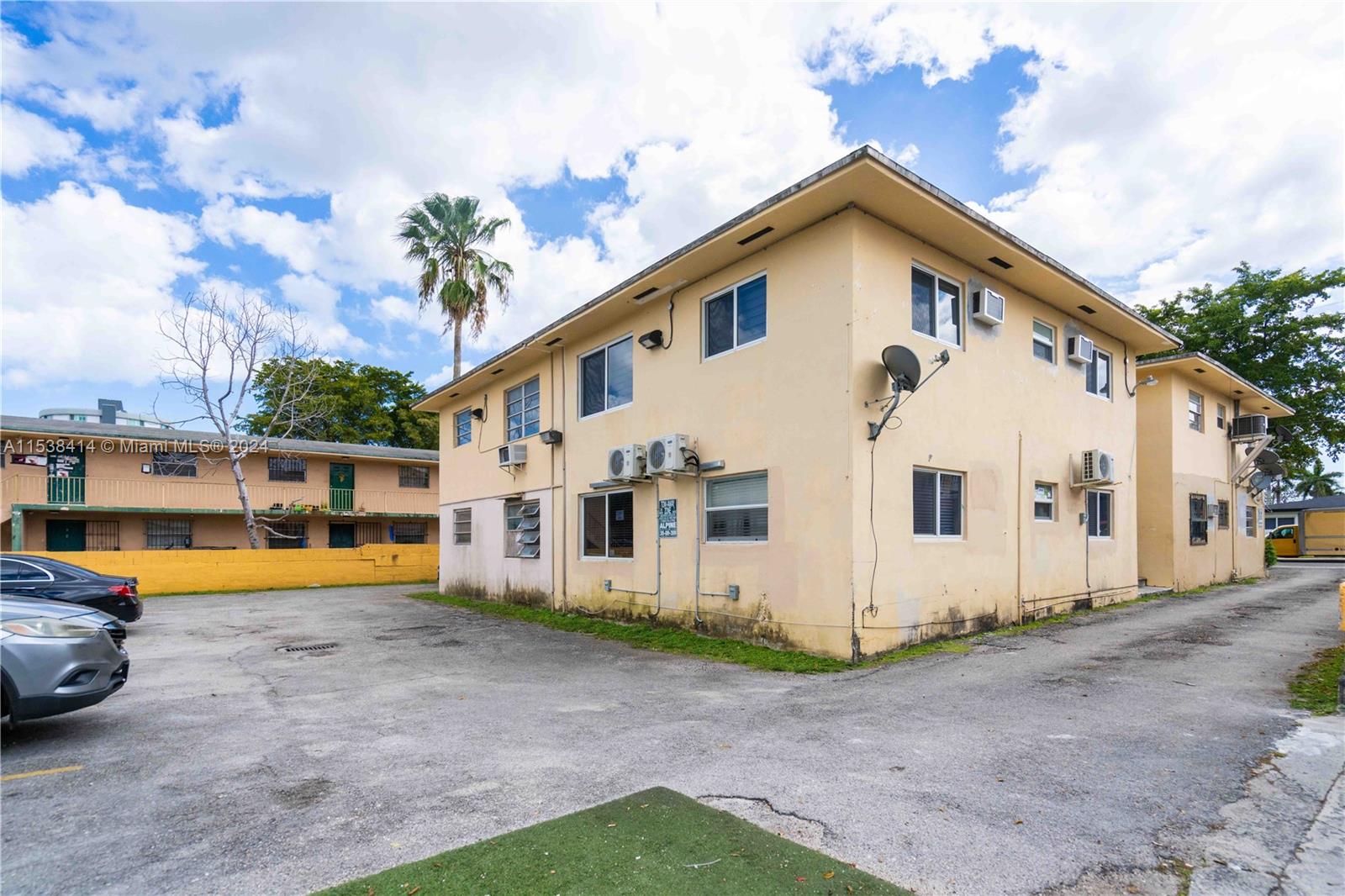 1945 Northwest 29th Street, Unit 8 Miami, FL 33142 - Photo 30 of 31 a view of a white house with a yard