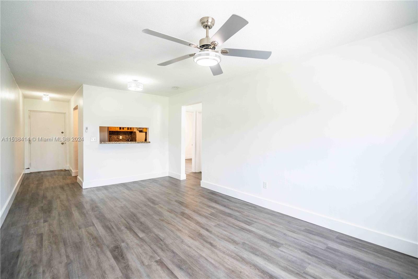 1945 Northwest 29th Street, Unit 8 Miami, FL 33142 - Photo 9 of 31 a view of a livingroom with wooden floor