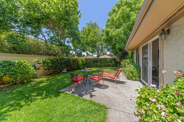 a view of a house with a backyard and garden