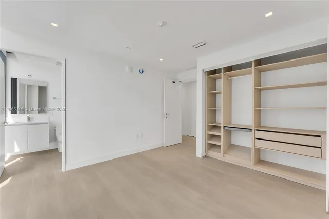 a view of a kitchen with a sink and a refrigerator