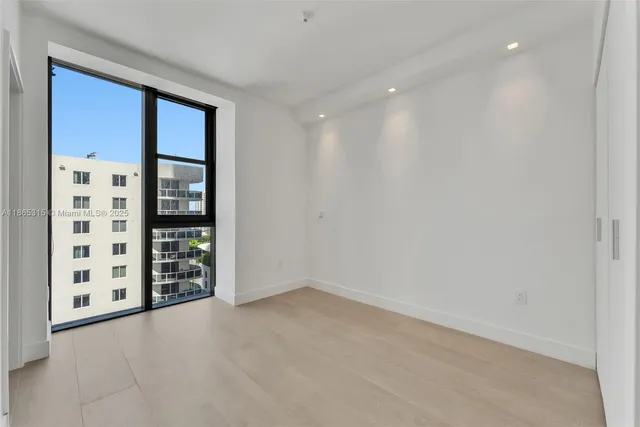 a view of an empty room with windows