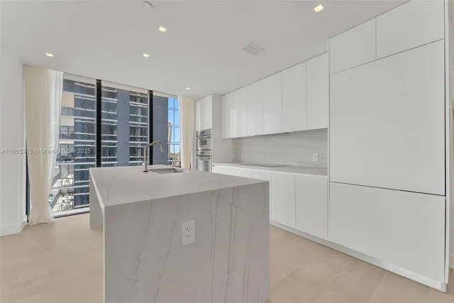 a kitchen with refrigerator and windows
