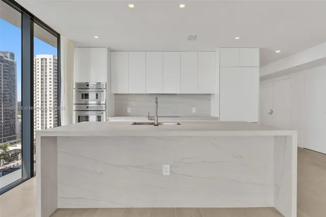 a kitchen with a sink cabinets and window
