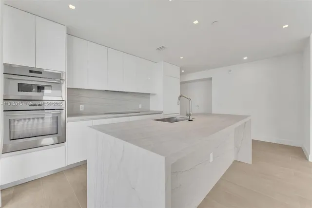 a kitchen with stainless steel appliances a sink and a stove top oven