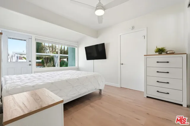 a bedroom with a bed and a flat screen tv