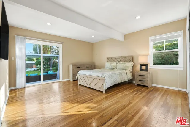 a bedroom with a large bed and a window