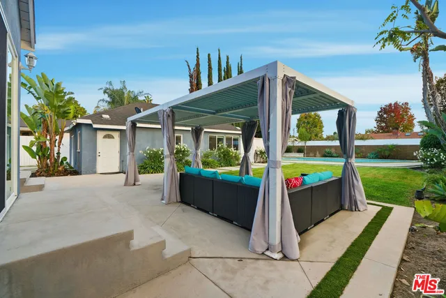 a front view of a house with a yard table and chairs