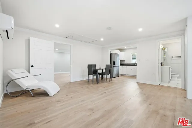 a view of a kitchen with kitchen island stainless steel appliances refrigerator stove microwave and cabinets
