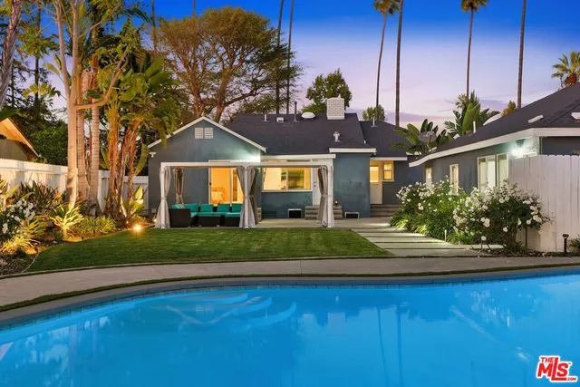 a view of a swimming pool with outdoor seating