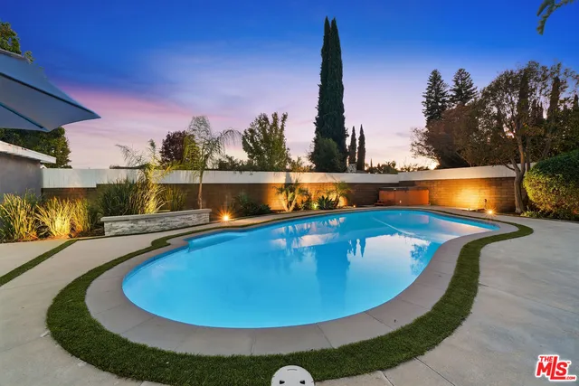 a view of a swimming pool with a yard